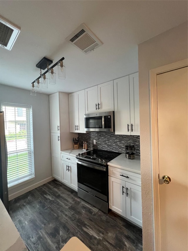 kitchen with stainless steel appliances and white cabinetry