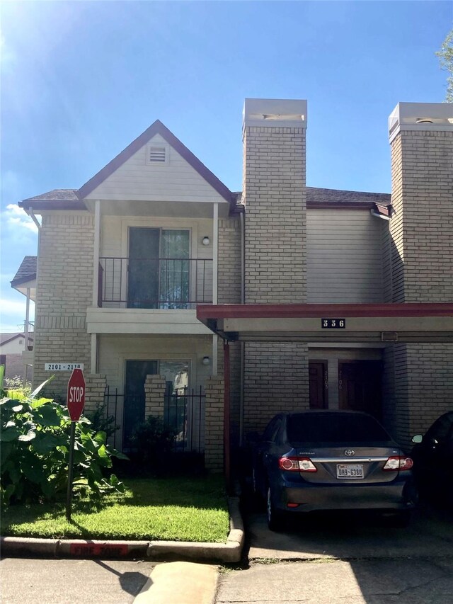 view of front of house featuring a balcony