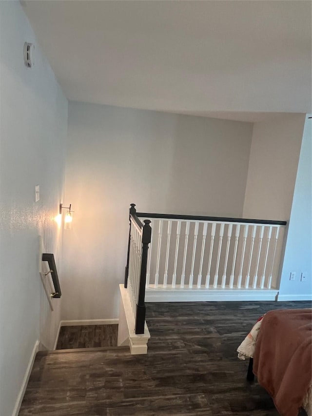 stairway with hardwood / wood-style floors