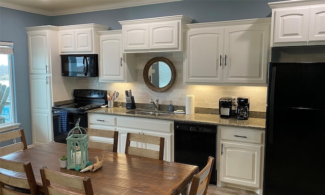 kitchen with white cabinetry, sink, black appliances, and light hardwood / wood-style floors