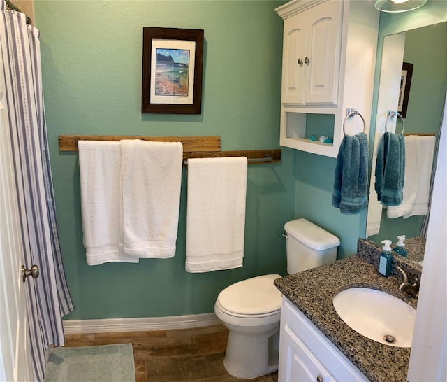 bathroom with hardwood / wood-style floors, vanity, and toilet