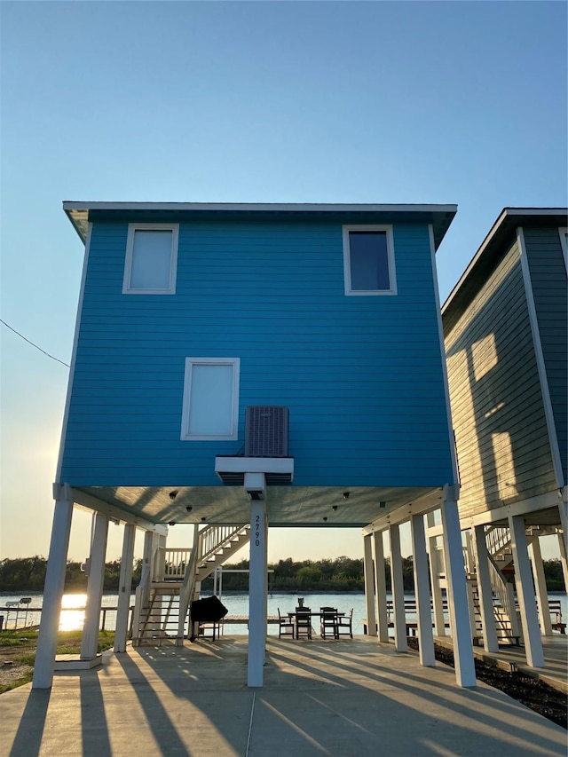 back of property featuring a water view