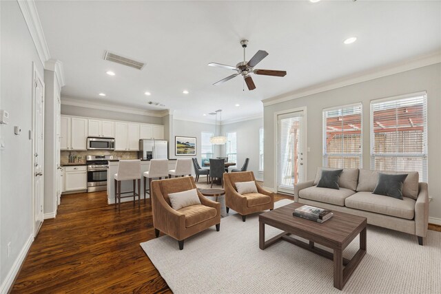 living room with dark hardwood / wood-style floors, ceiling fan, and ornamental molding