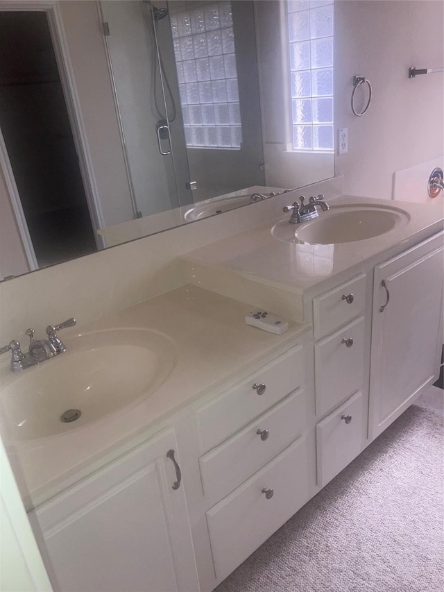 bathroom featuring a shower and vanity