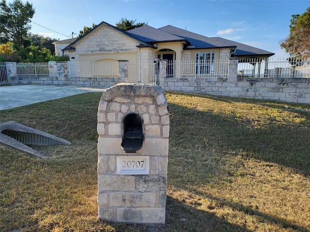 view of front of property with a front yard and a garage