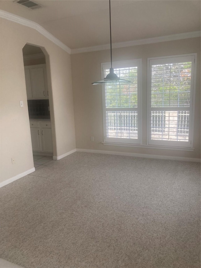 interior space featuring light carpet, vaulted ceiling, and ornamental molding