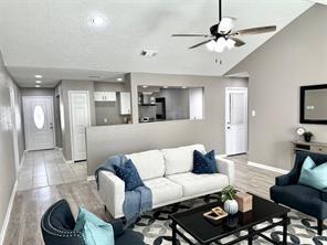 living room featuring lofted ceiling and light hardwood / wood-style flooring