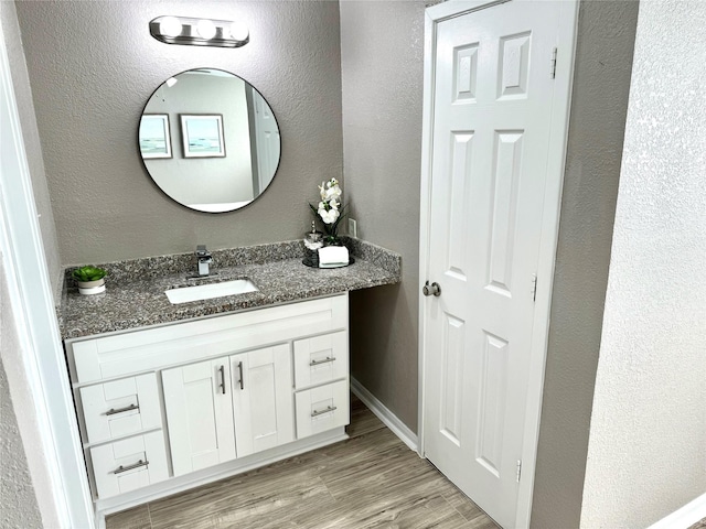 bathroom with hardwood / wood-style floors and vanity