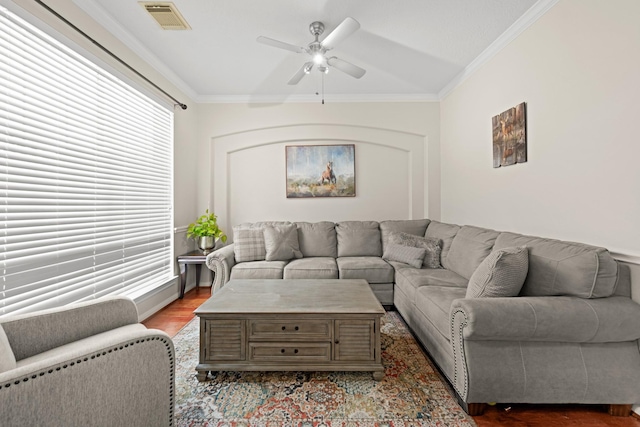 living room with hardwood / wood-style floors, ceiling fan, and crown molding