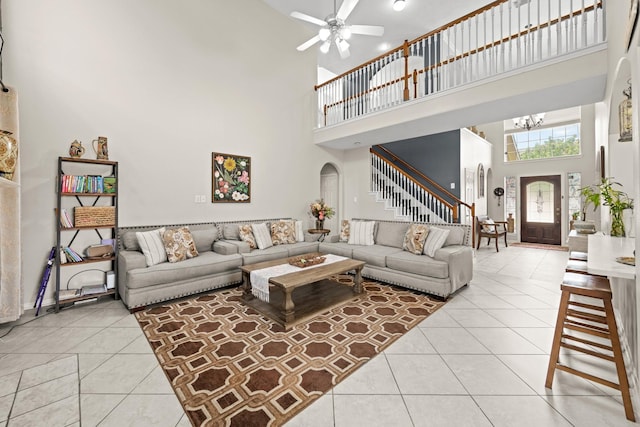 tiled living room with a towering ceiling and ceiling fan