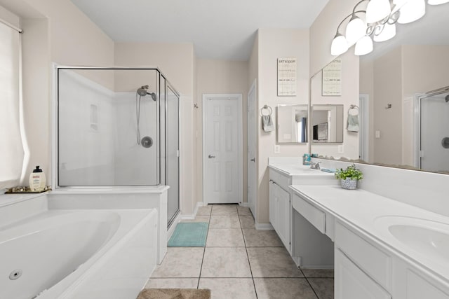 bathroom featuring tile patterned flooring, vanity, an inviting chandelier, and shower with separate bathtub