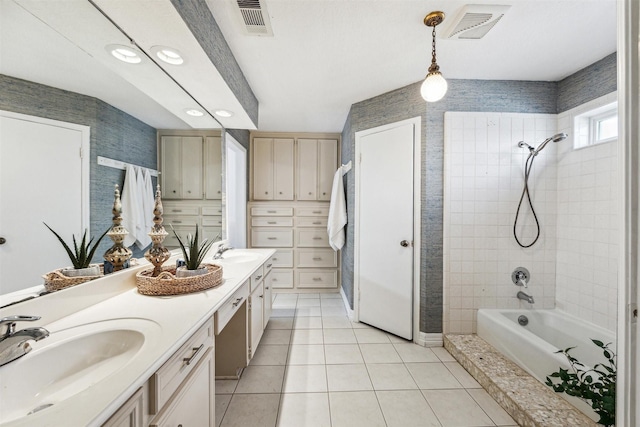 bathroom featuring tile patterned floors, vanity, and tiled shower / bath