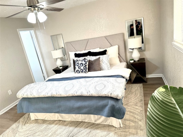 bedroom with ceiling fan and hardwood / wood-style flooring