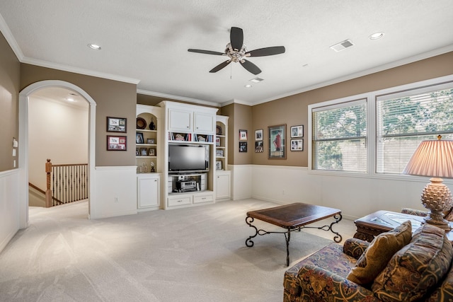 living room with light carpet, crown molding, a textured ceiling, and ceiling fan