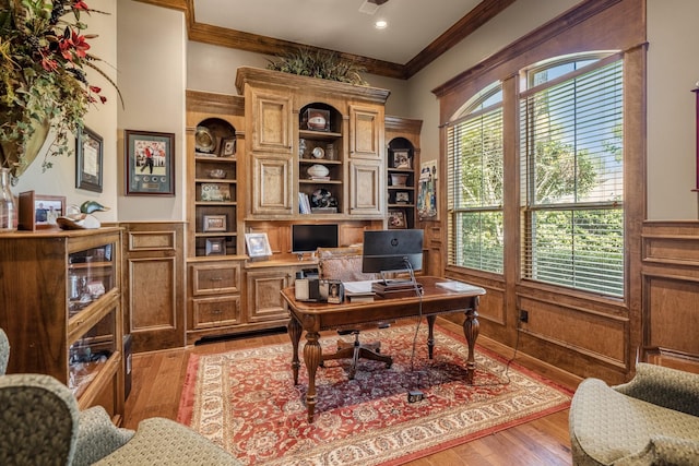 office space with ornamental molding and light hardwood / wood-style flooring