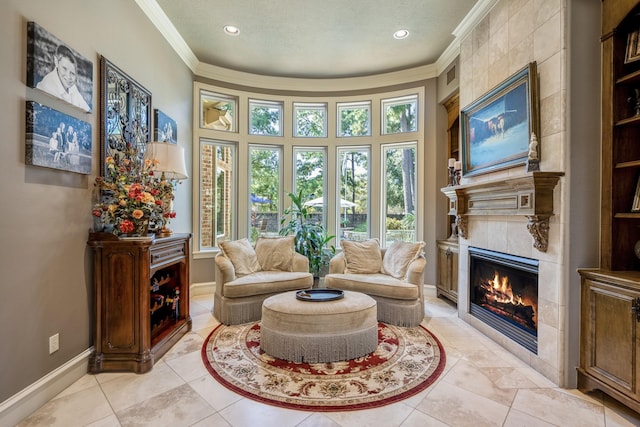 sitting room with a fireplace, crown molding, and plenty of natural light