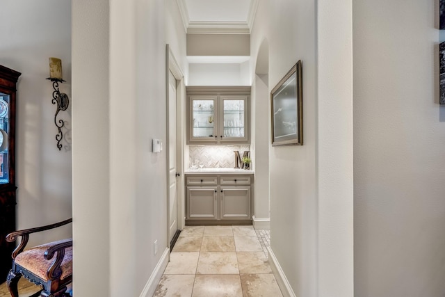 hall featuring crown molding and light tile patterned floors