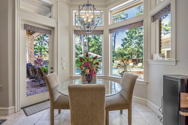 dining room with an inviting chandelier and plenty of natural light