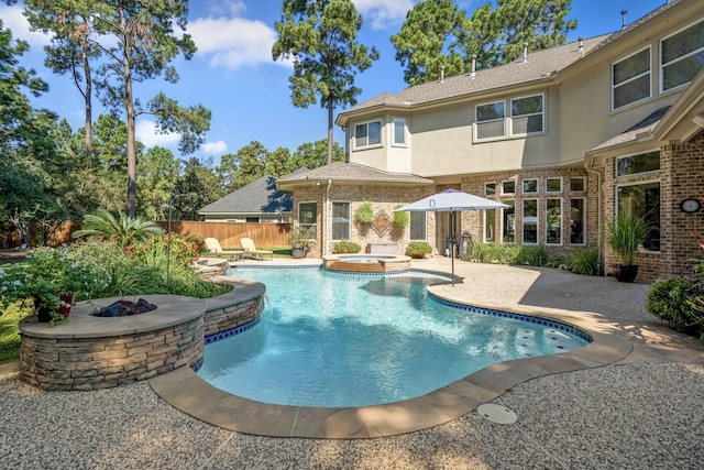 view of swimming pool with a fire pit, a patio, and an in ground hot tub