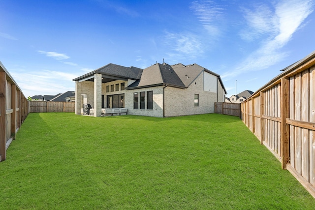 rear view of property with a lawn