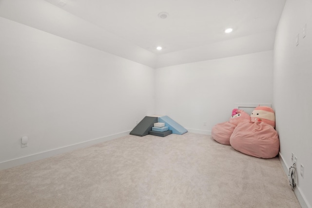 recreation room with carpet and vaulted ceiling