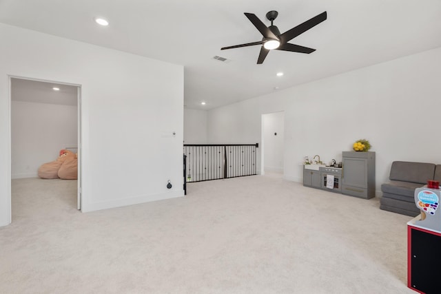 living room featuring ceiling fan and light carpet