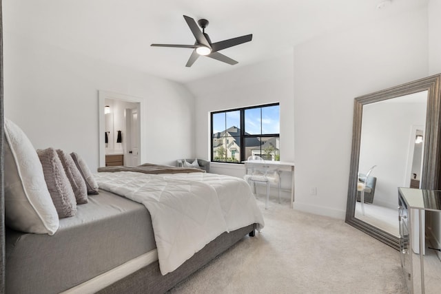 bedroom featuring ceiling fan, light colored carpet, lofted ceiling, and ensuite bathroom