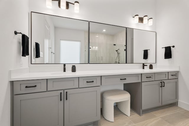 bathroom with tile patterned floors, vanity, and walk in shower