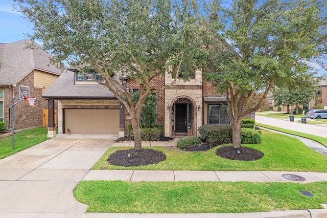 view of front of home with a front yard and a garage