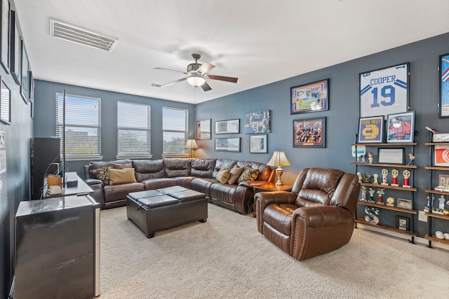 living room with ceiling fan and light colored carpet