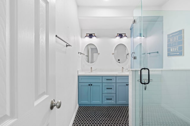 bathroom with vanity and a shower with door