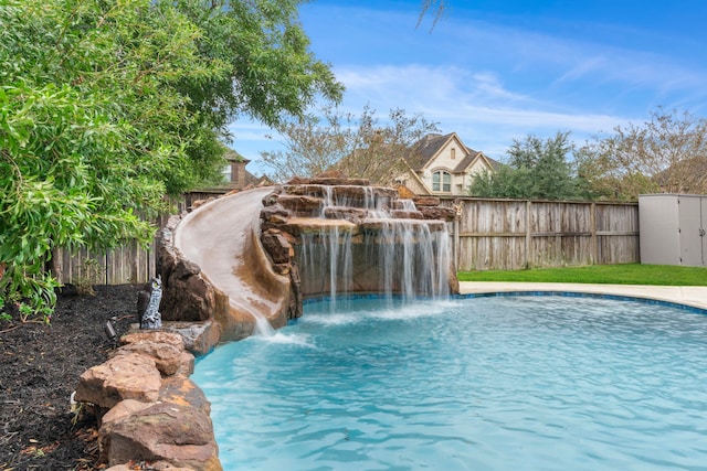 view of pool with pool water feature