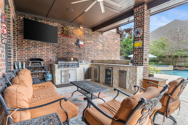 view of patio featuring an outdoor hangout area, exterior kitchen, grilling area, a fenced in pool, and wine cooler