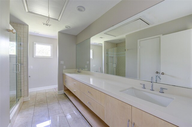 bathroom with tile patterned flooring, vanity, and a shower with shower door