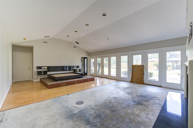 unfurnished living room with light wood-type flooring and vaulted ceiling