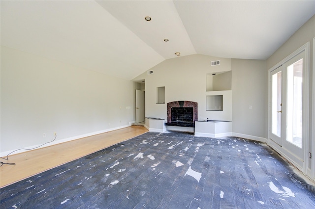 unfurnished living room with hardwood / wood-style floors and lofted ceiling