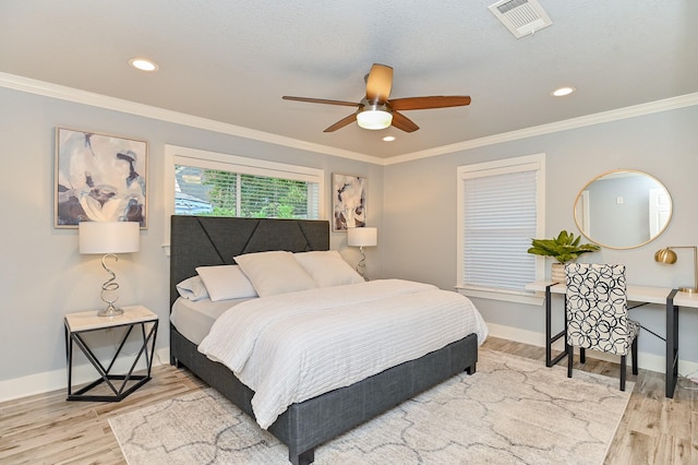 bedroom featuring hardwood / wood-style flooring, ceiling fan, and ornamental molding