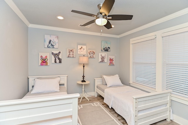 bedroom featuring ceiling fan, light hardwood / wood-style floors, and ornamental molding