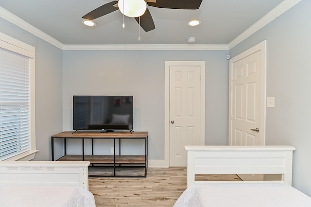 bedroom featuring light wood-type flooring, ceiling fan, and ornamental molding