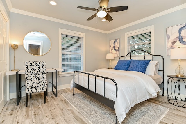 bedroom featuring ceiling fan, light wood-type flooring, and ornamental molding