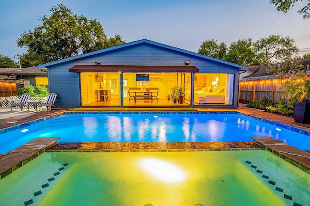 pool at dusk with a patio