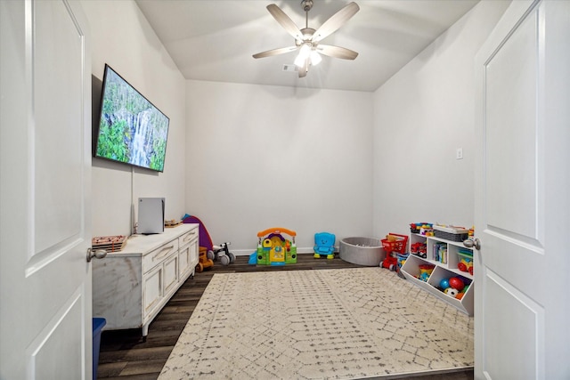 game room with ceiling fan and dark wood-type flooring