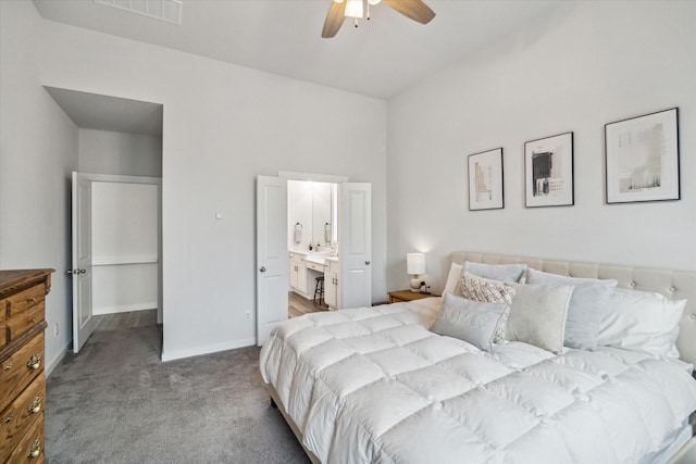 bedroom with ceiling fan, light colored carpet, and connected bathroom