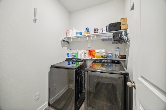 clothes washing area featuring hardwood / wood-style flooring and independent washer and dryer