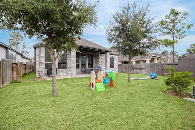 rear view of property with a yard and a patio