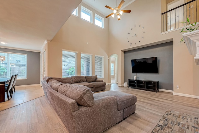 living room featuring ceiling fan, light hardwood / wood-style floors, and plenty of natural light