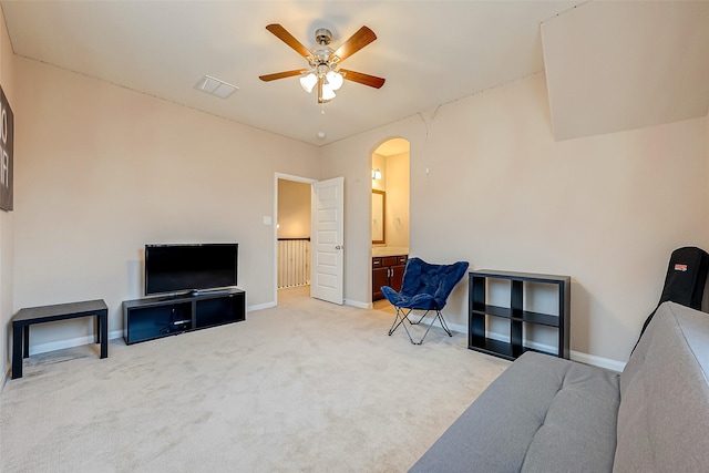 living room with light colored carpet and ceiling fan