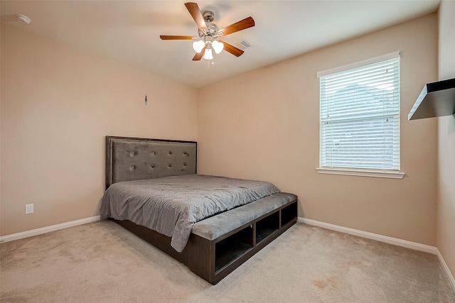 bedroom with ceiling fan and light carpet