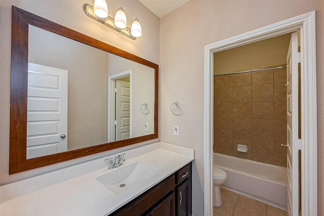 full bathroom with tile patterned flooring, vanity, tiled shower / bath combo, and toilet