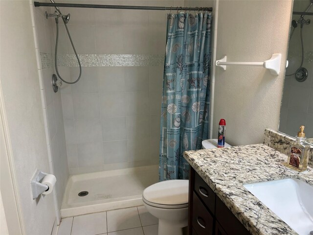 bathroom with tile patterned flooring, a shower with curtain, toilet, and vanity